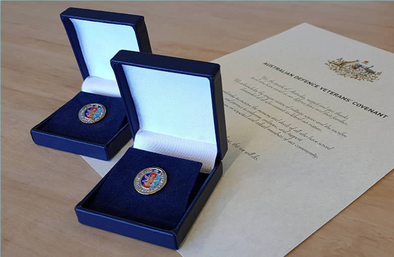 Lapel pins in boxes with an official letter